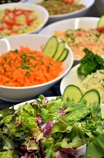 Leafy green salads with cucumbers, rice, and other grains.